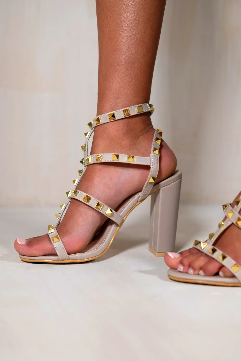 BLOCK HEEL WITH STUDDED GLADIATOR STRAPS IN NUDE FAUX LEATHER